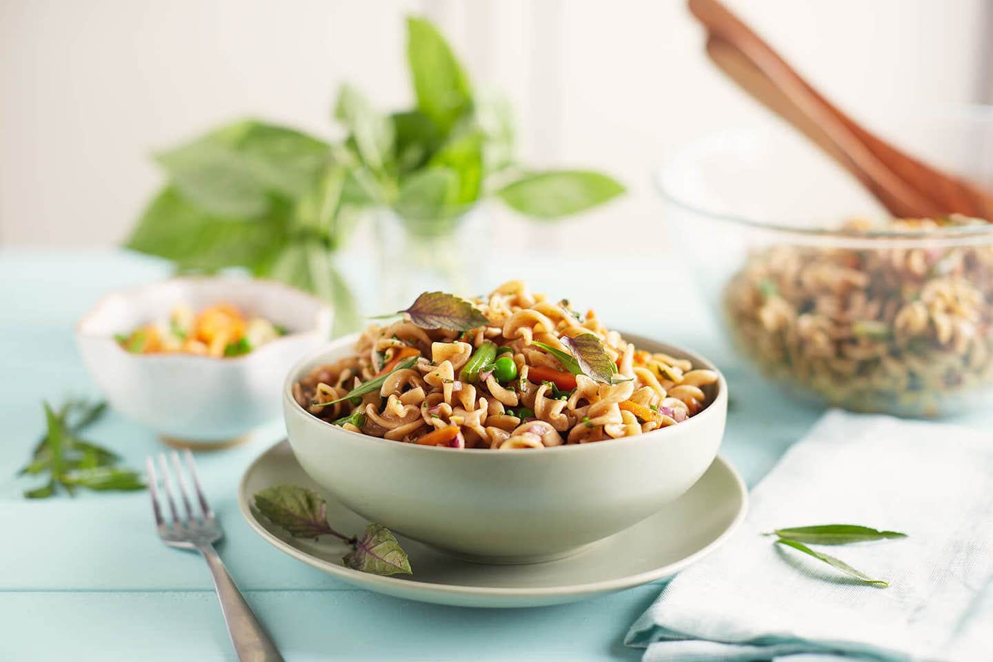 Easy Vegan Pasta Salad in a white bowl sitting on a white plate