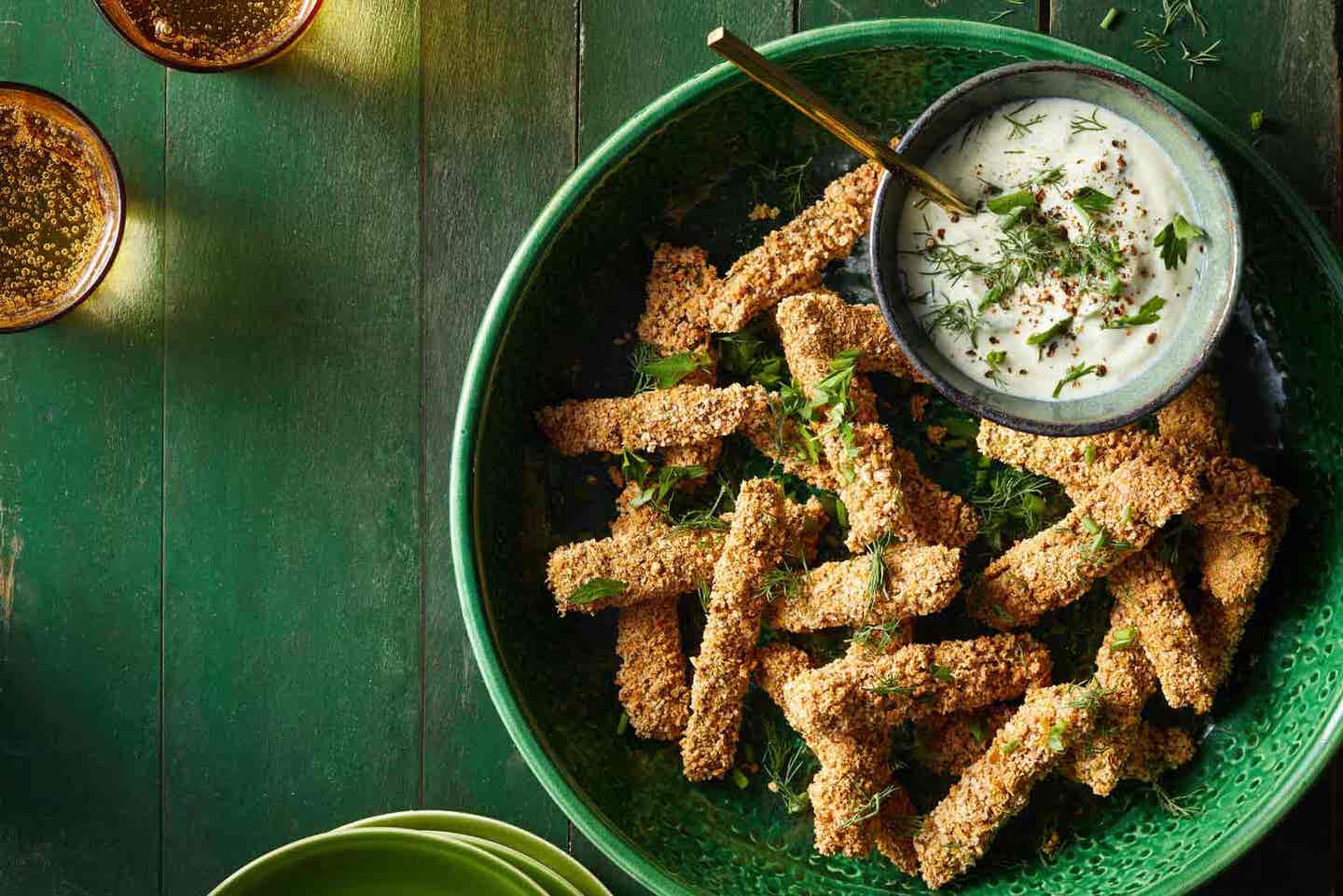 Nopales cactus fries on a platter with a creamy dipping sauce