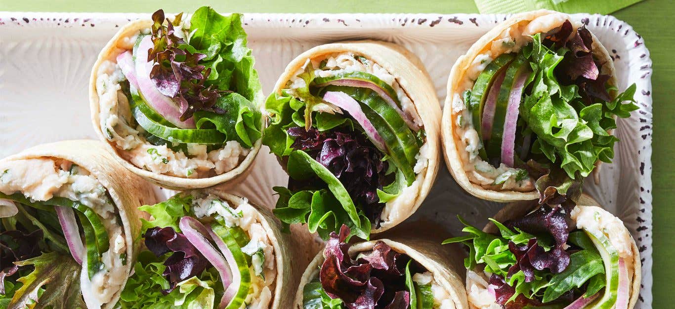 White Bean Wraps with Pickled Cucumber and Mint on a white tray