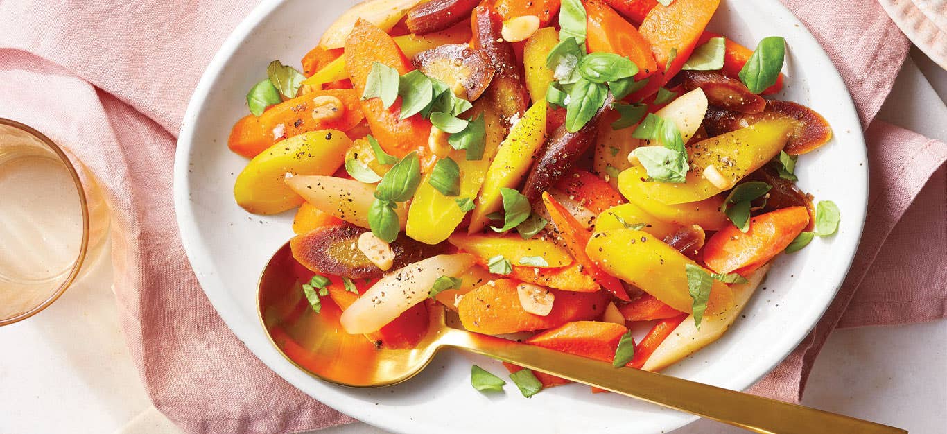 Basil and Garlic Poached Carrots on a white serving platter