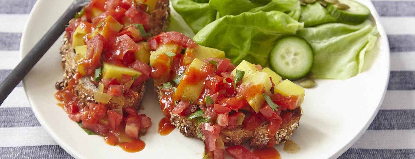 Vegan Potato Scramble with Hot Chile Sauce on a plate with lettuce and cucumber