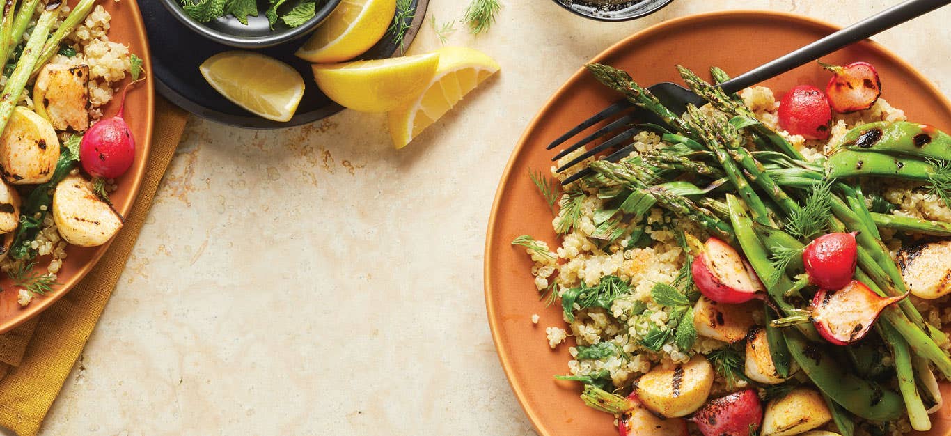 Quinoa Pilaf Primavera on orange plates with a metal fork