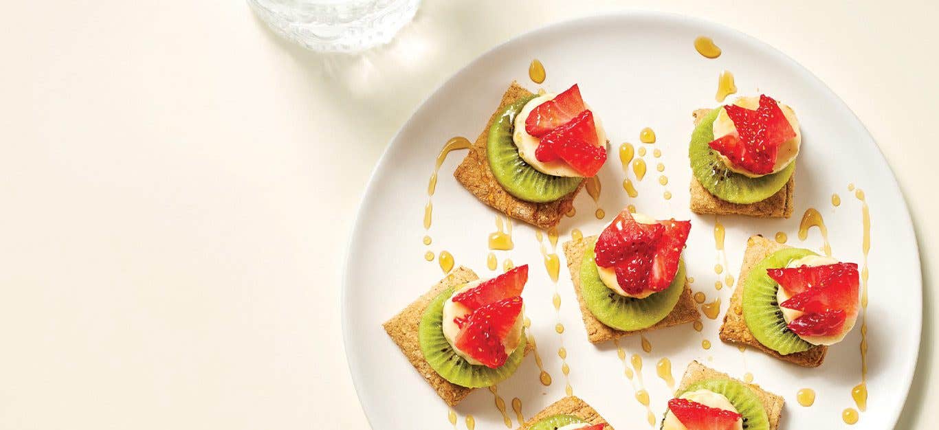 Walnut Biscuit Stacked Fruit Appetizers on a white plate against a cream background