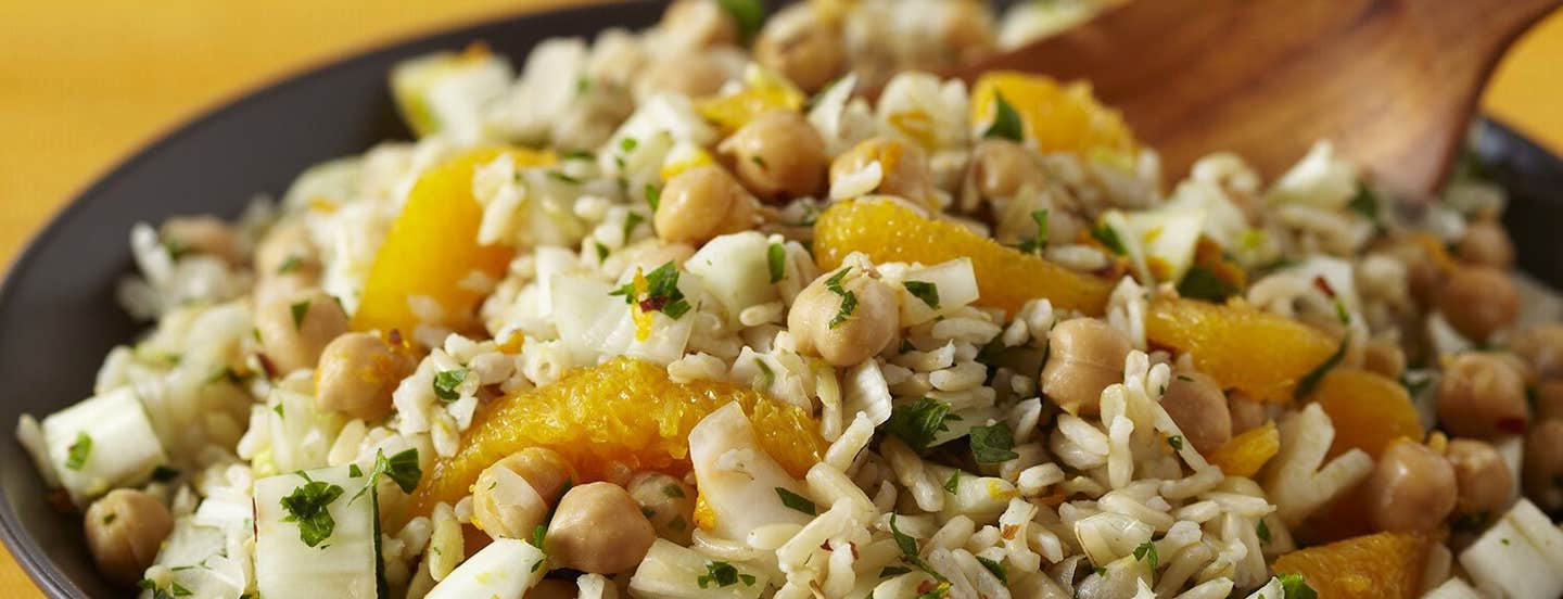 A bowl of rice salad with oranges and chickpeas