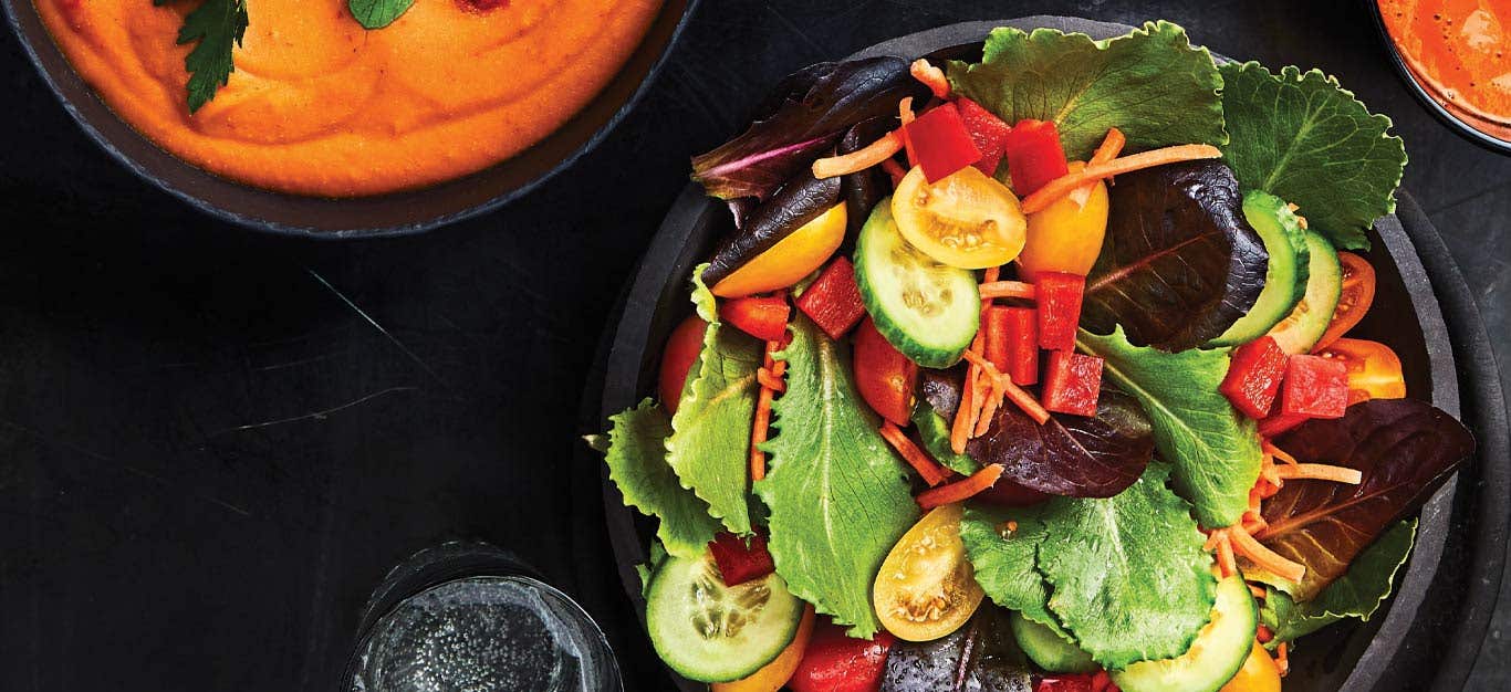 Rainbow Veggie Salad with Creamy Harissa Dressing in a black bowl