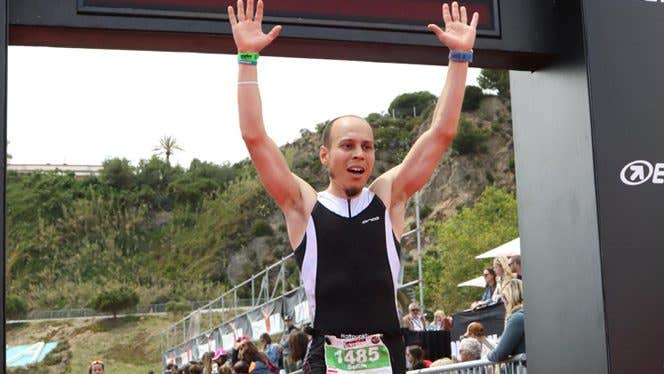 Man crosses marathon finish line after recovering from back pain