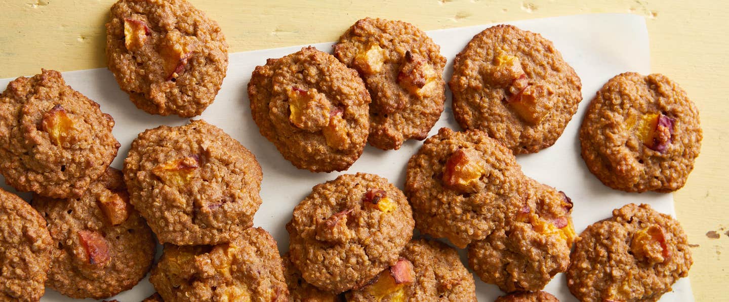 More than a dozen Stone Fruit and Quinoa Breakfast Cookies on parchment paper