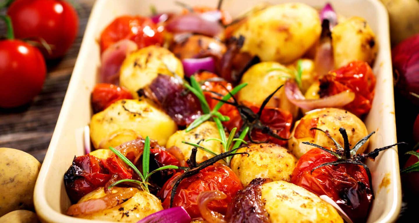 Potato and Onion Bake with Rosemary and Tomatoes in a casserole dish