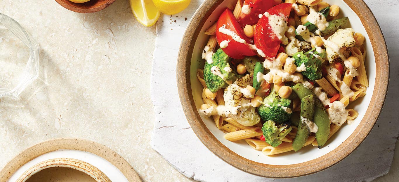 Summer Noodle Bowls with Grilled Veggies and Cashew Cream Sauce in white and tan ceramic bowls