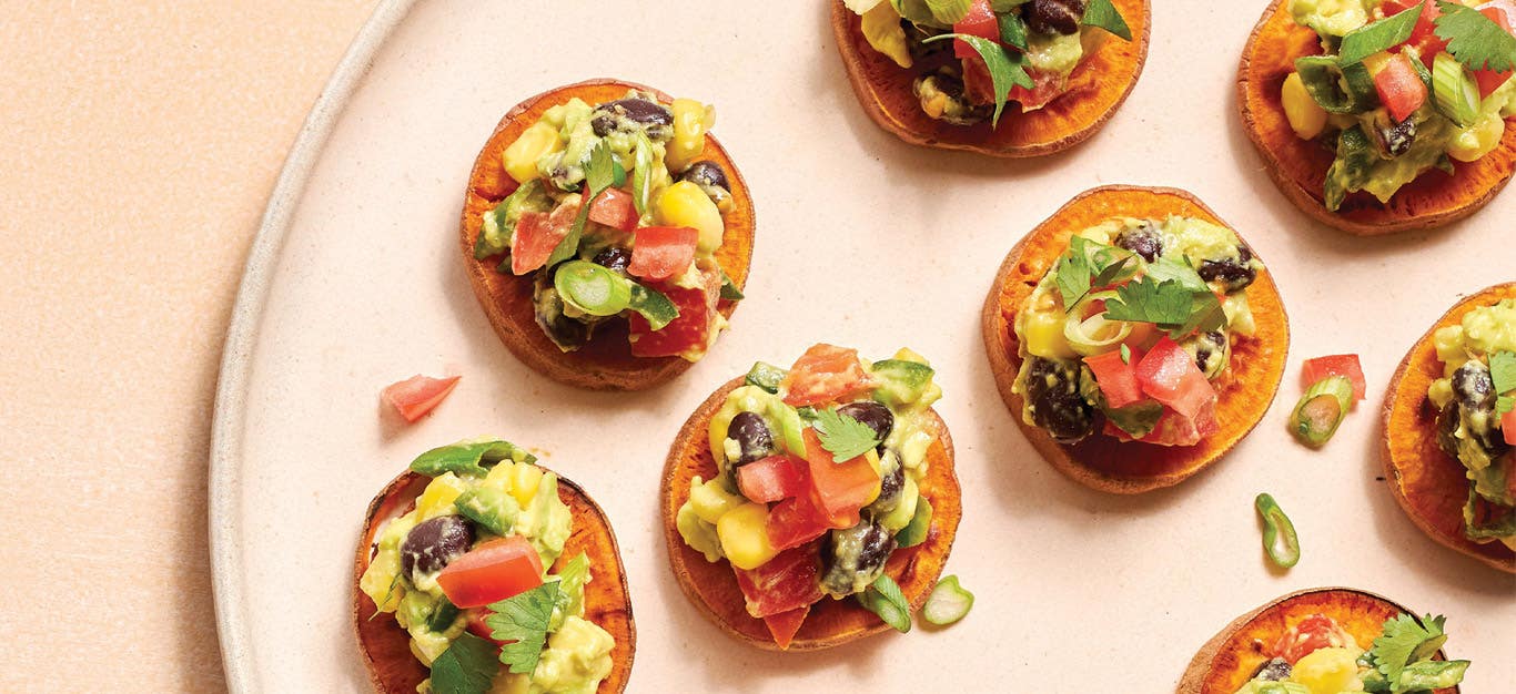 Sweet Potato Crostini with Avocado Salsa on a light pink serving tray