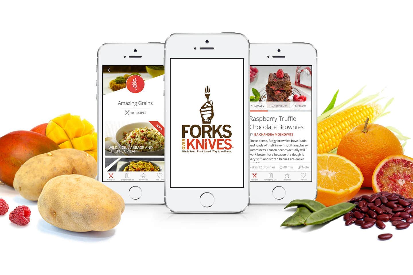 Three mobile phones showing the Forks Over Knives app, on a white background next to fresh fruits and vegetables