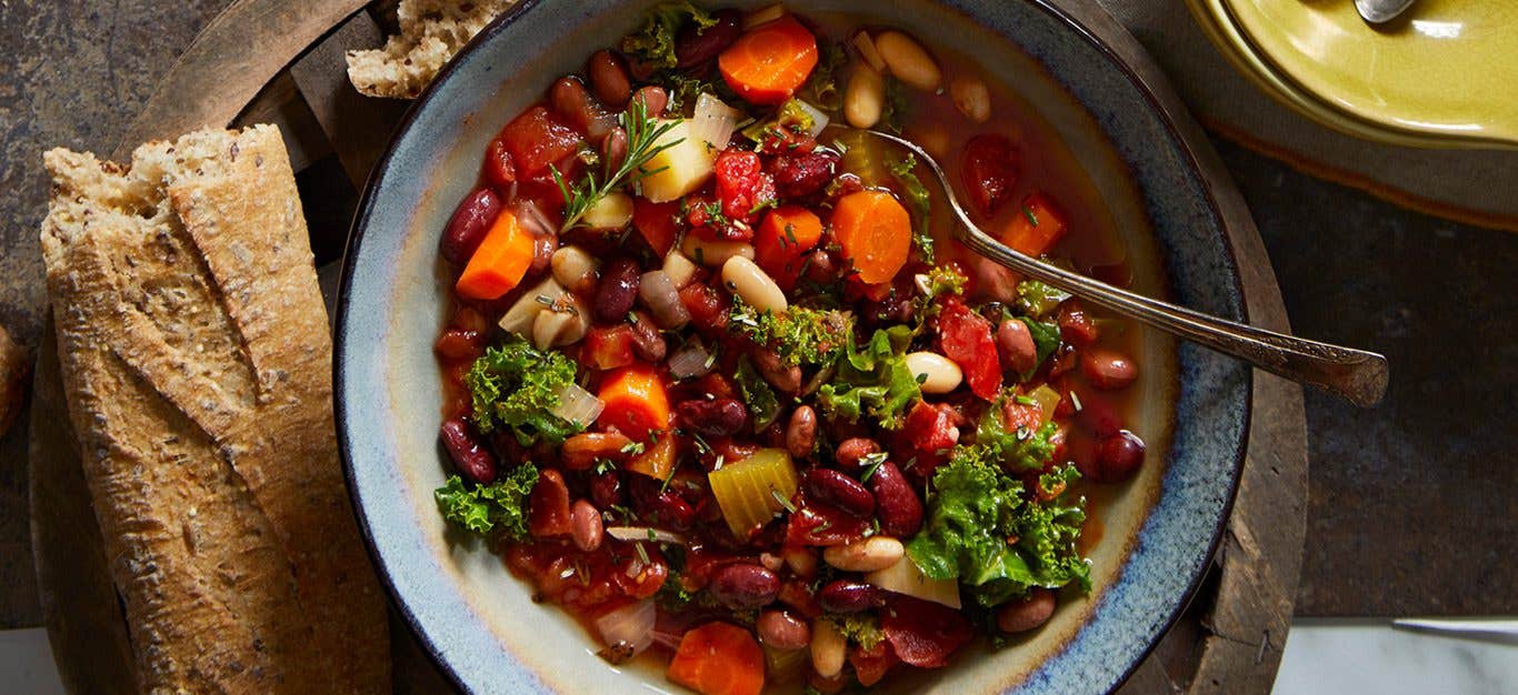 vegan cassoulet cooked in slow cooker with red beans, kidney beans, kale, carrots and more