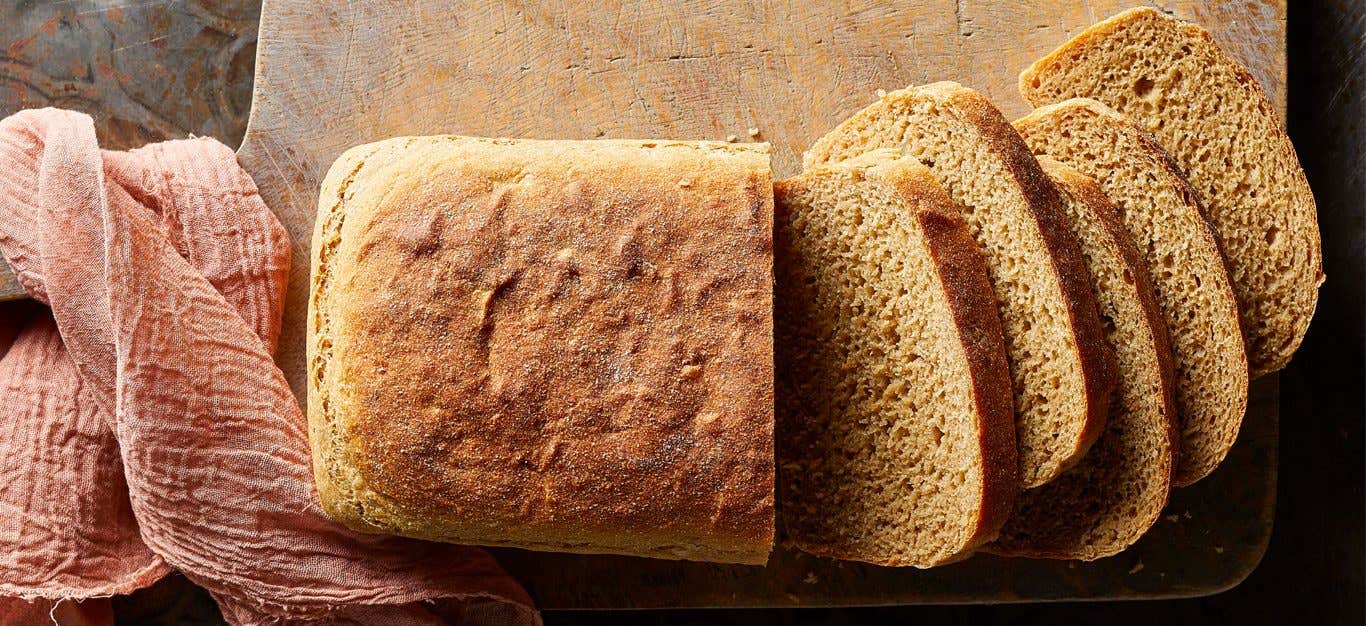 Vegan Potato Bread cut into slices on a wood board