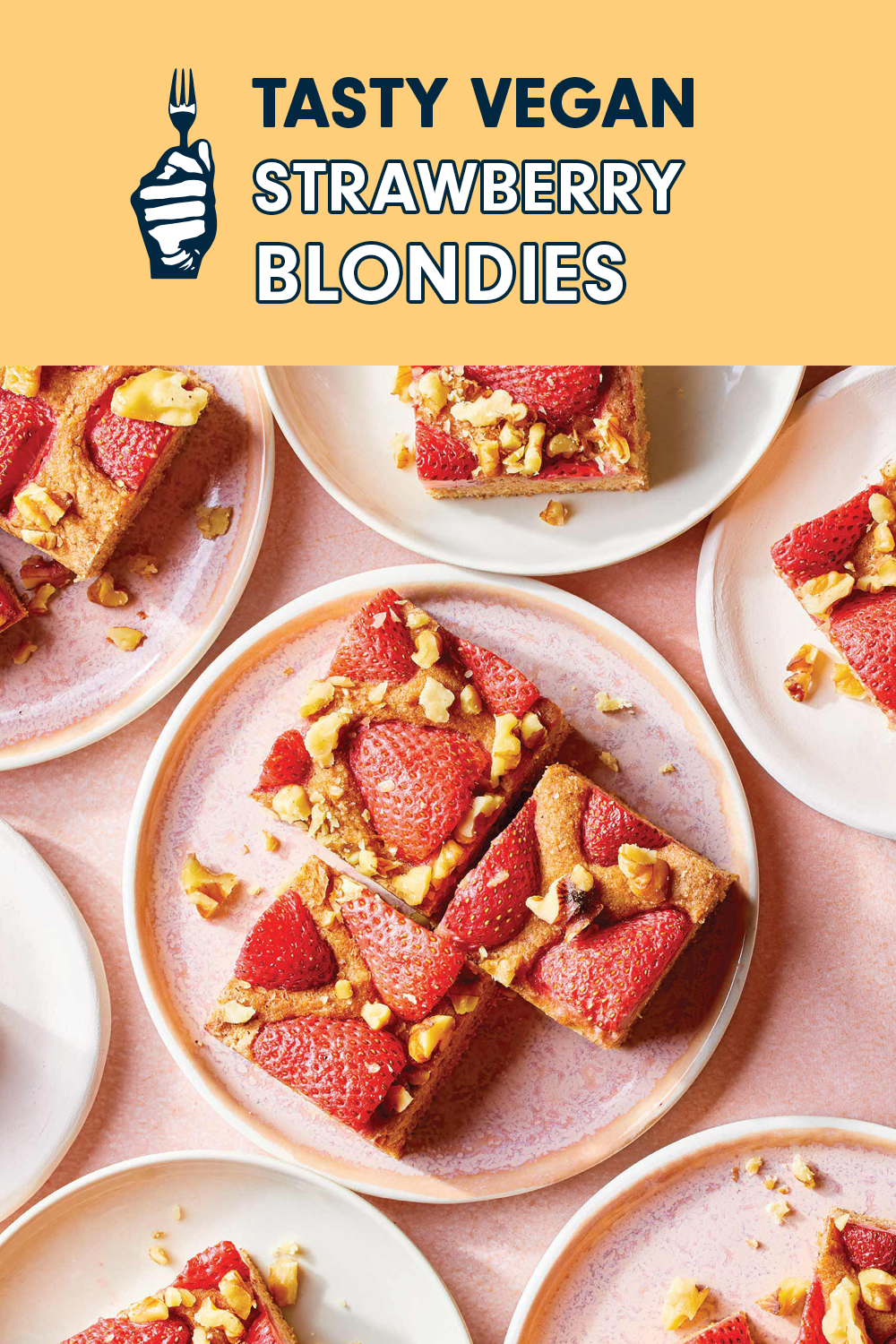 An assortment of pink and white plates served with a slices topped with strawberries. The title reads, "Vegan Strawberry Blondies"