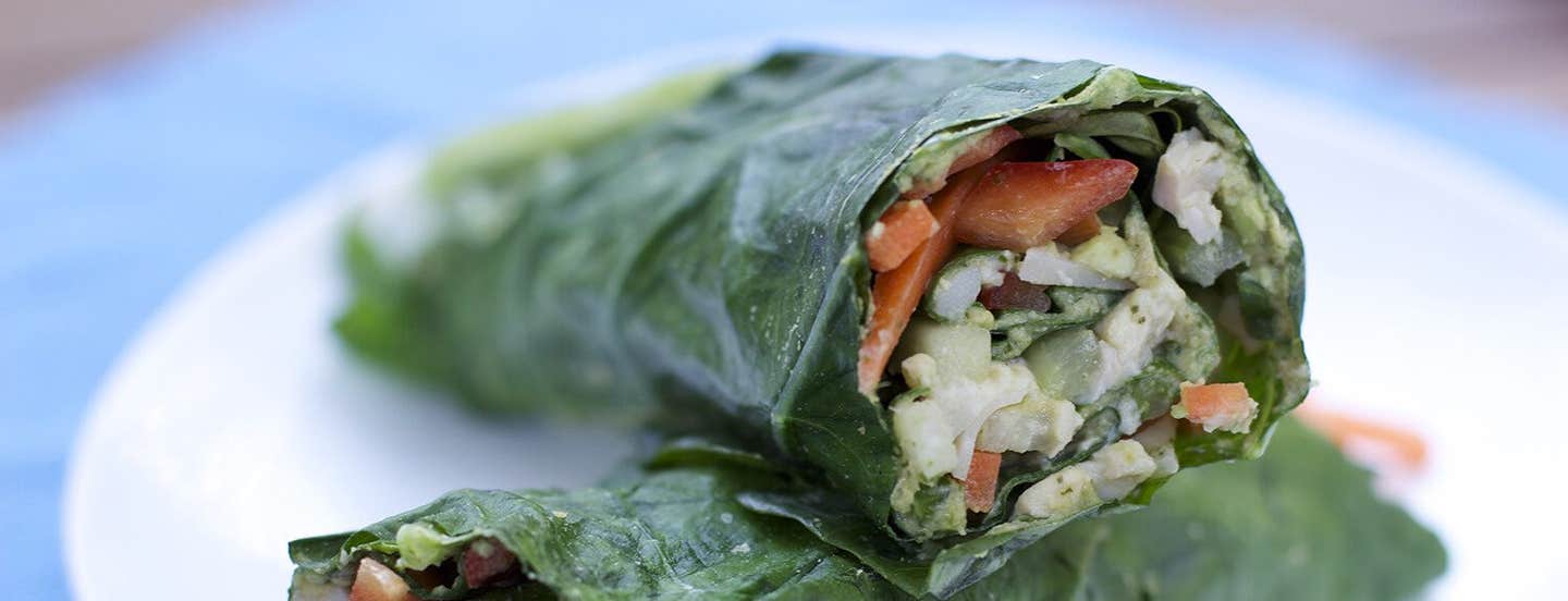 Veggie Wraps with Herbed Hummus on a white plate, cut in half, with one up on top of the other