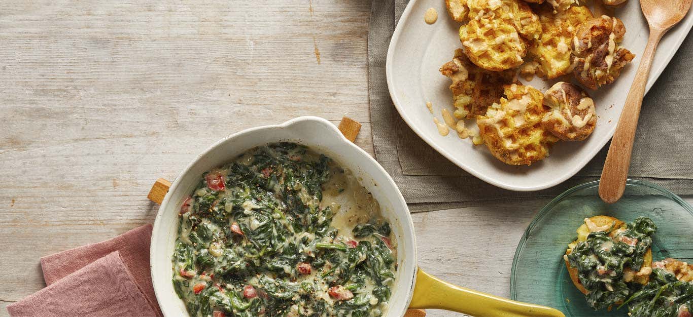 Waffled Smashed Potatoes with Creamed Spinach on white plates