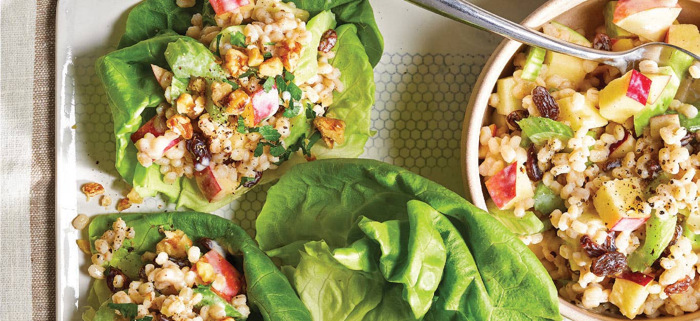 Vegan Waldorf Salad on lettuce leaves placed on a white serving tray