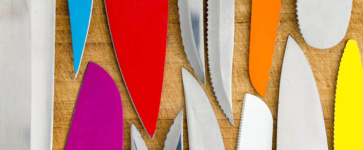 An array of kitchen knife blades, all different colors and sizes