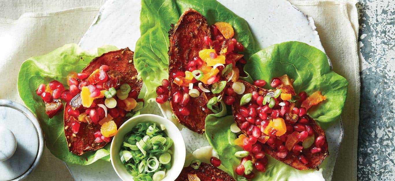 Za'atar Sweet Potato Lettuce Cups next to a small bowl of sliced scallions on a white background