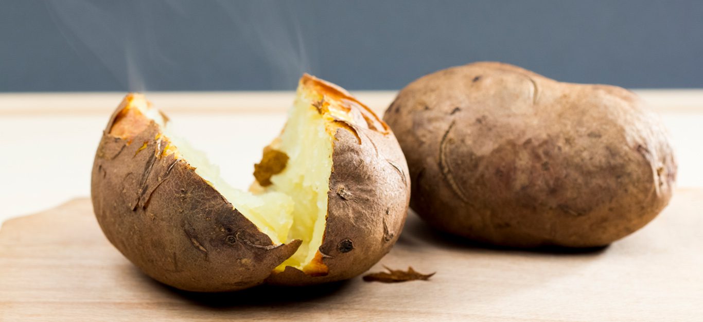 https://www.forksoverknives.com/uploads/a-steaming-hot-baked-potato-just-from-the-oven-cut-in-half.jpg?auto=webp