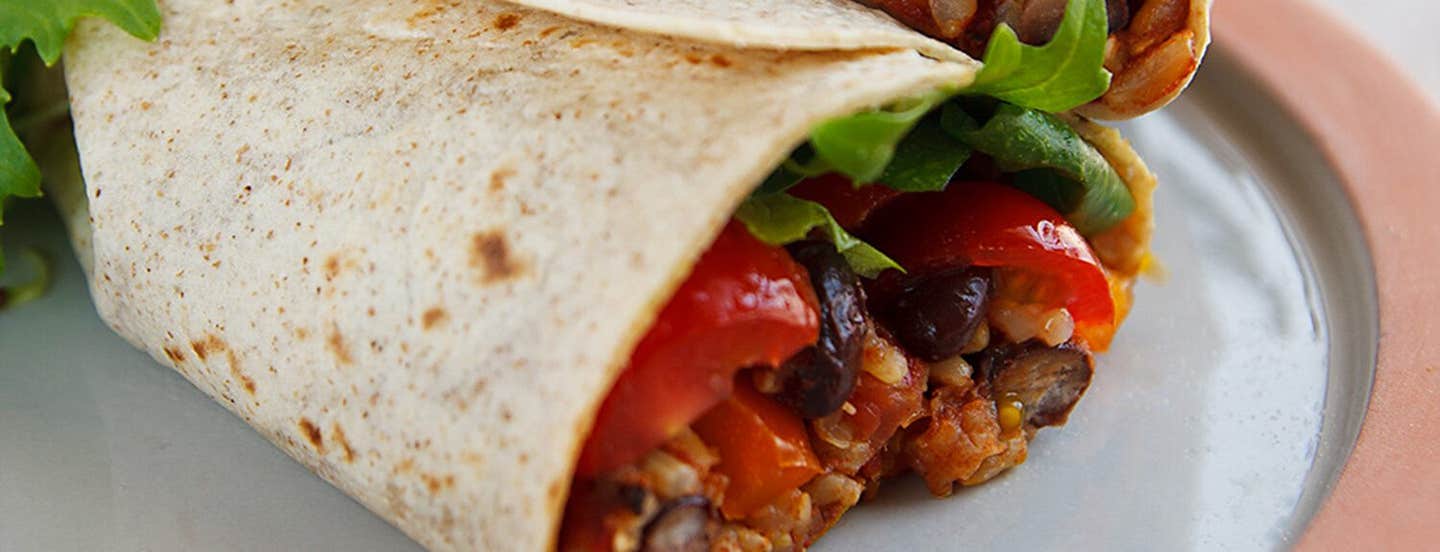 Close-up of one end of a Burrito with Spanish Rice and Black Beans on a plate