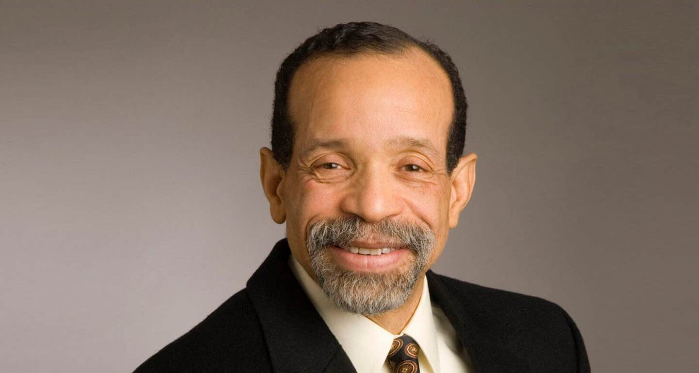 Headshot of Cardiologist Dr. Kim Williams wearing a suit and tie, smiling