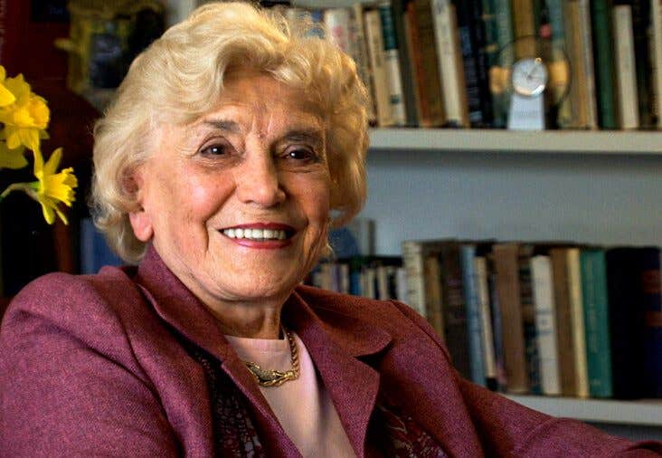 Evelyn Oswick at home in front of a large book shelf