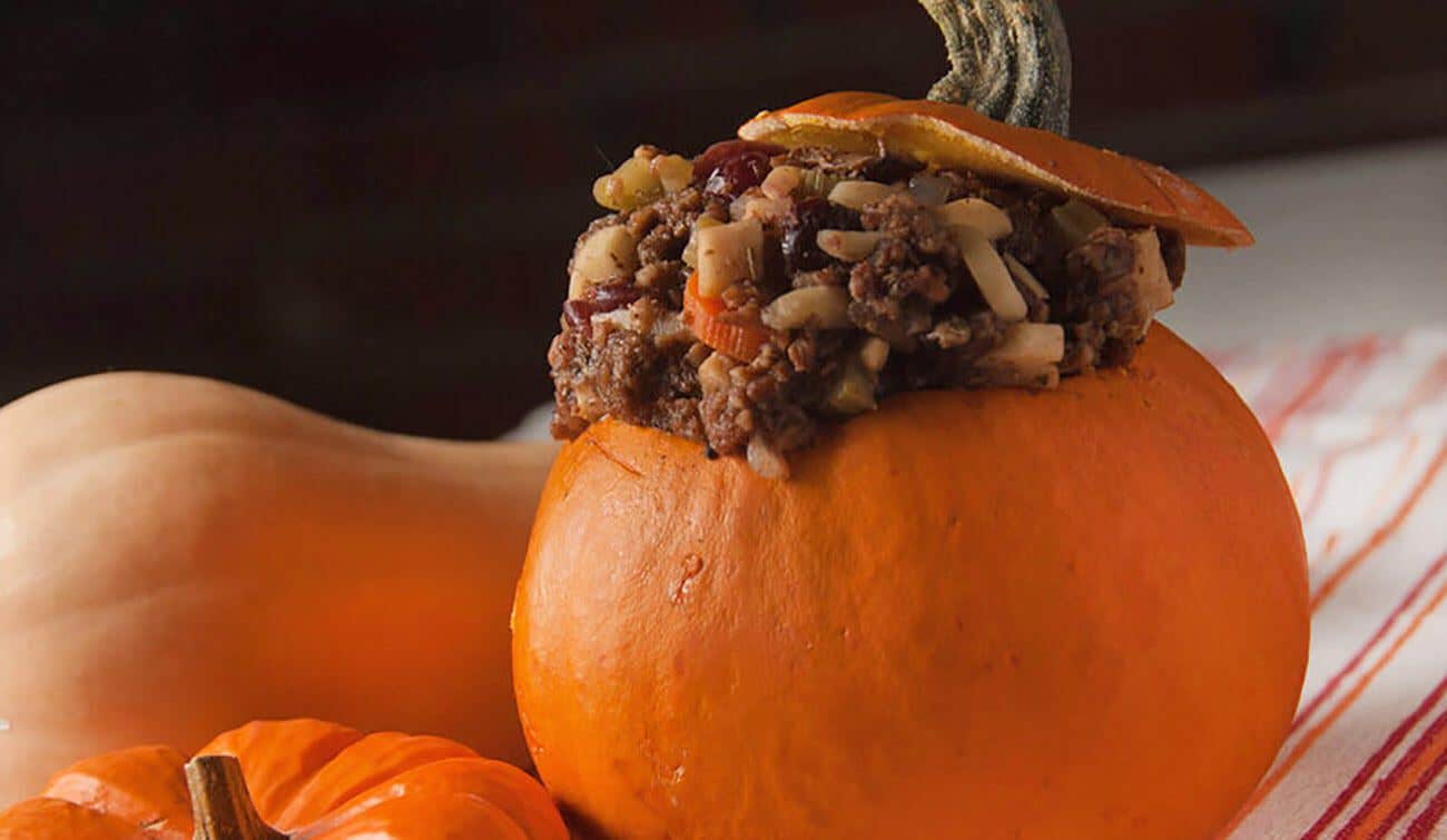 Close up of a large pumpkin stuffed with a hearty mix of lentils and veggies, aka Fire Brigade Stuffing