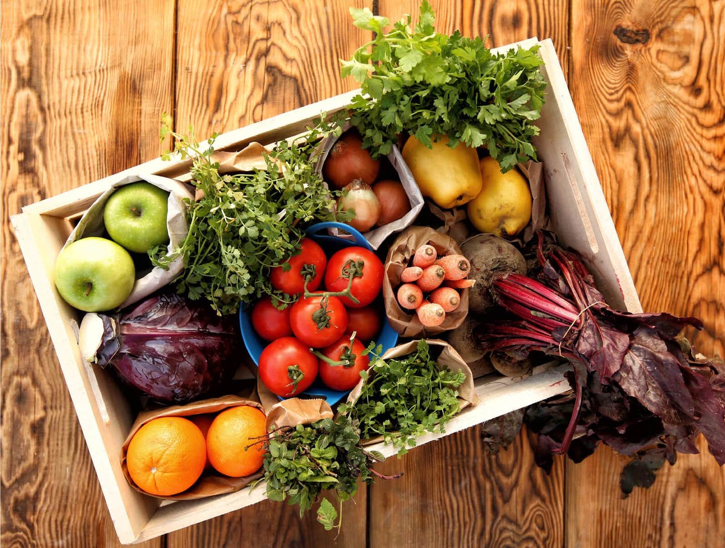 Looking down at a basket of fresh fruits and vegetables