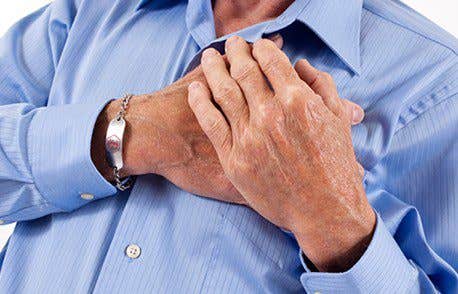 Unidentified man in a blue business suit clutches his chest