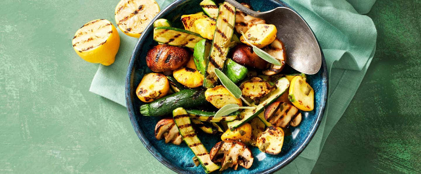 A top-down view of a bowl of Grilled Squash and Mushrooms with Fresh Herbs