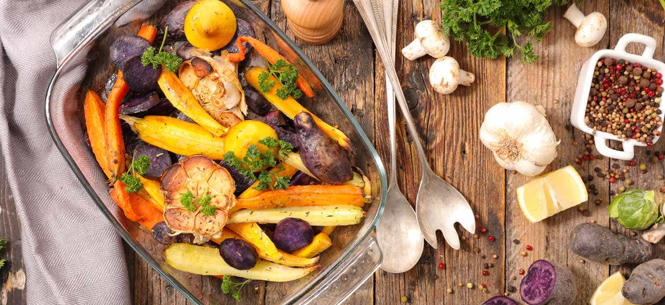 A casserole dish of carrots and other root vegetables roasted without oil