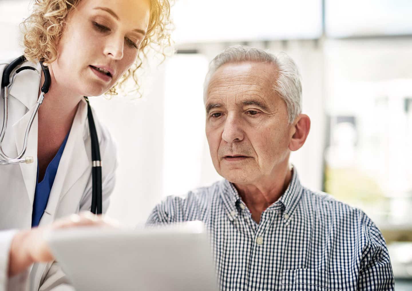 Shot of a doctor showing a senior patient some information on a digital tablet in her office