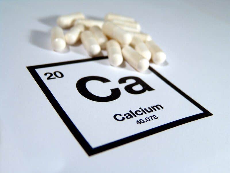 Calcium tablets on a cut out of the Calcium bock from the periodic table