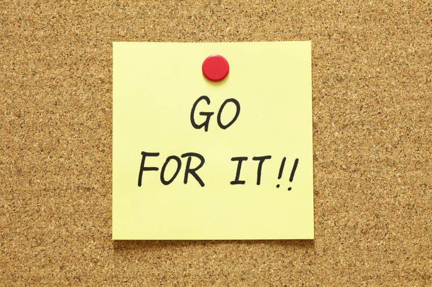 Post-it note pinned to cork board, with the words "GO FOR IT!!" written on it