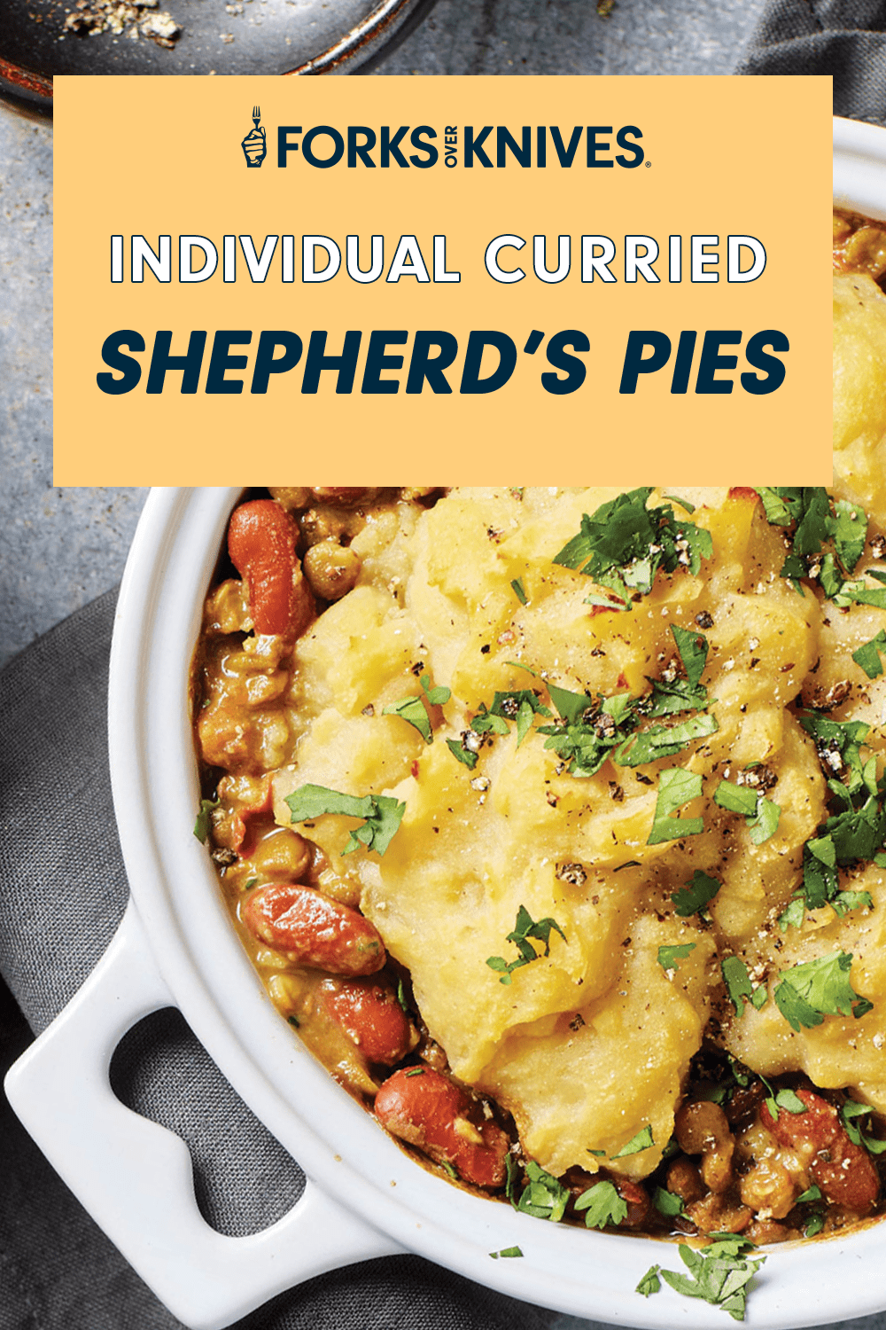 A close-up of a serving-size ramekin filled wth a potato topped veggie pie. Text above reads, "Individual Curried Shepherd’s Pies"