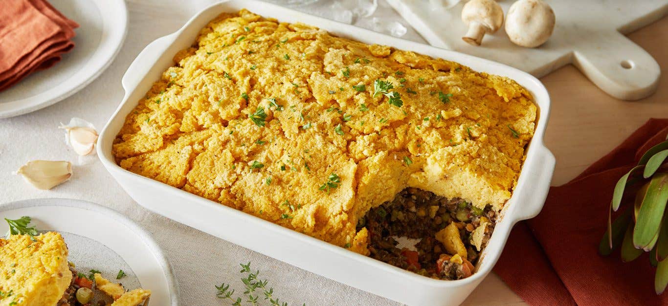 A white casserole dish of Vegan Shepherd's Pie with Polenta and Lentils