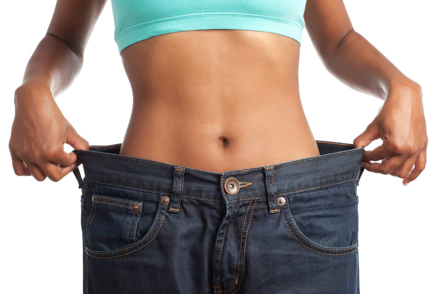 The torso of a slim women wearing pants that are miles too big for her, holding the waistband out to the sides