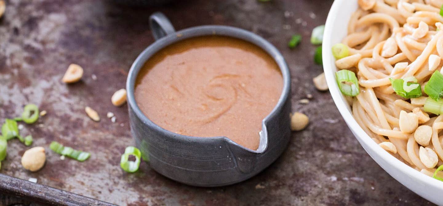 A grey jug of peanut sauce