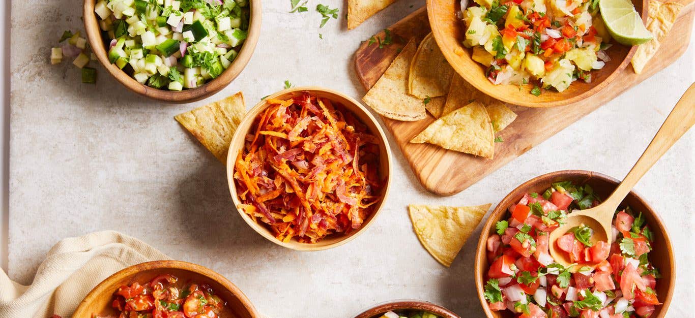 Looking down at a table of different bowls filled a variety of appetizing healthy vegan salads