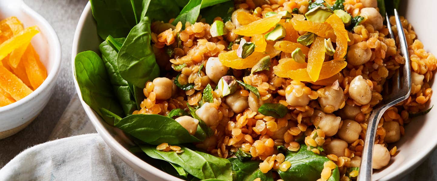 Spinach-Apricot Salad with Spiced Lentils next to a small bowl of dried apricot slices