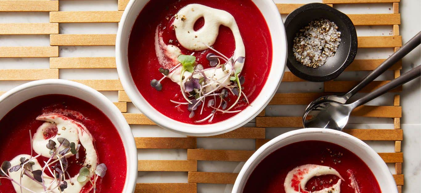 Springtime Beet Soup in white bowls on a wooden lattice placemat