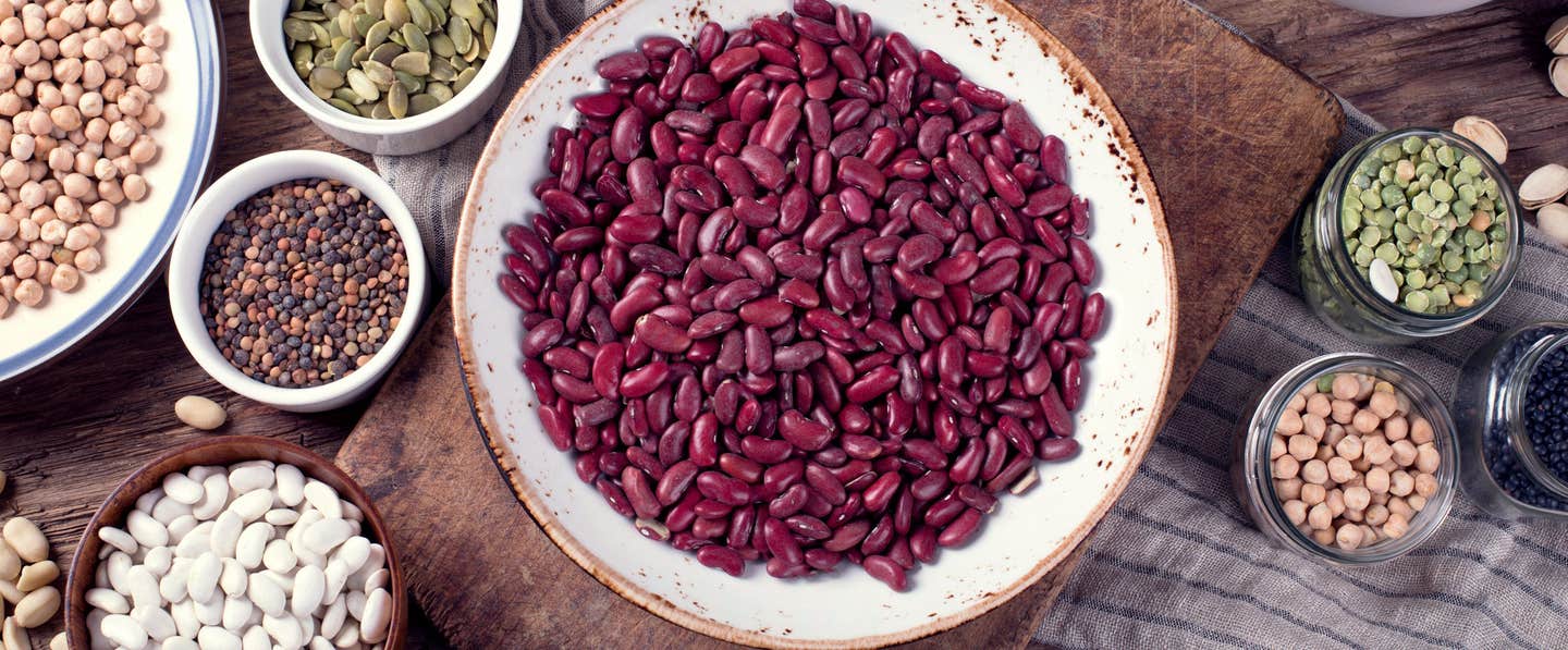 Various plates filled with beans such as kidney beans, chickpeas, and lentils