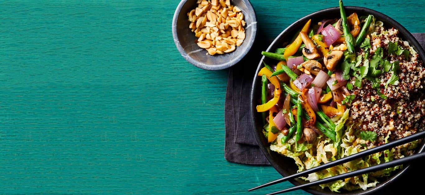 Thai Grain Bowls with black chopsticks on a blue wood table