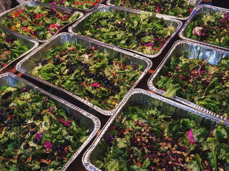 Trays of prepared salad at a Community Solidarity event