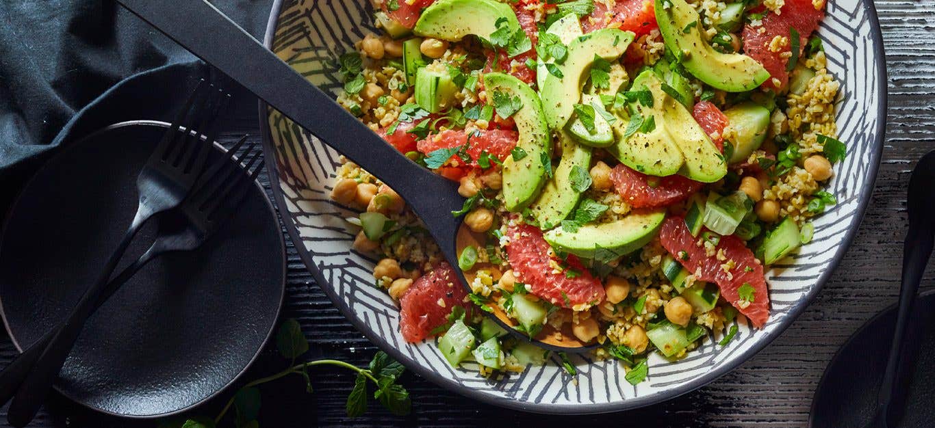 Freekeh grapefruit tabbouleh salad - avocado and grapefruit slices atop a colorful tabbouleh inspired salad