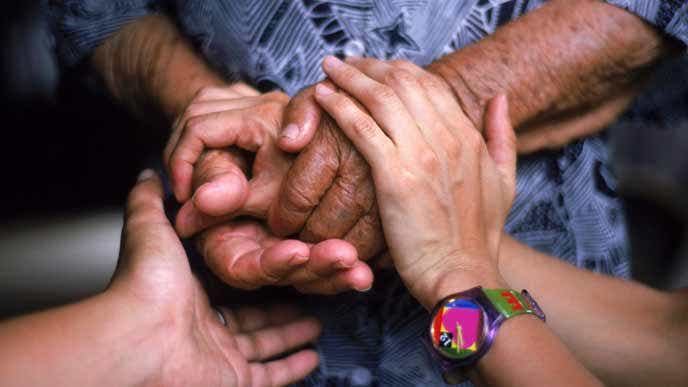 Young hands holding old, wrinkled hands