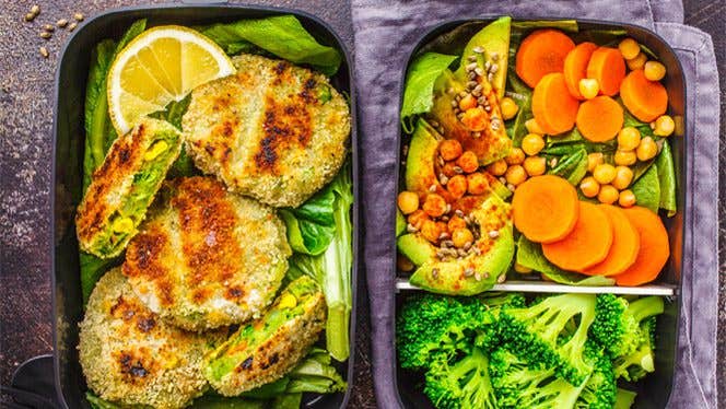 Bento boxes full of fresh salad and veggie burgers