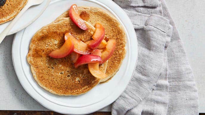 Layered Cinnamon-Apple pancakes on a white plate