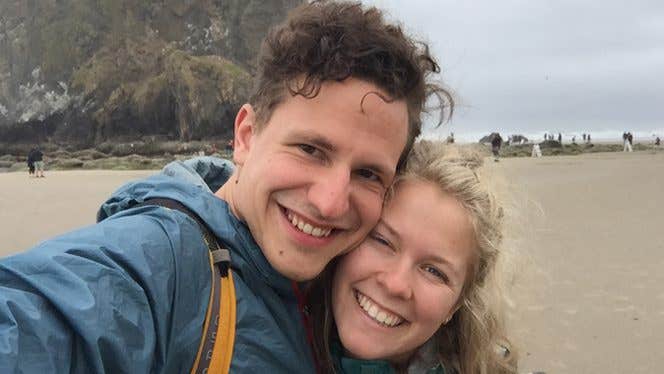 Young woman and man selfie on beach